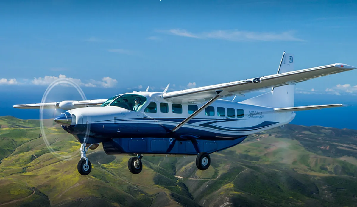 Cessna Grand Caravan EX turboprop in flight over green hills